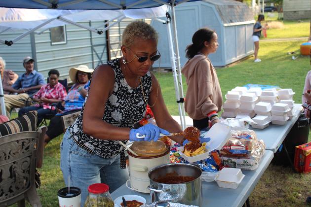 Demetria Bivens prepares chili nachos.