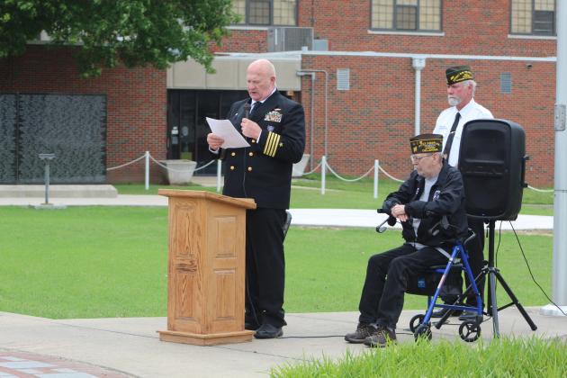 Navy Captain David Stevens reads "In Flanders Fields."