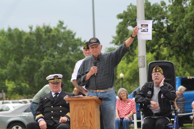 Veterans Memorial Committee member Al Brase speaks as Navy Captain David Stevens, VFW Post 1317 Commander-elect Patrick "Gunny" Koch and the VFW Chaplain looks on.