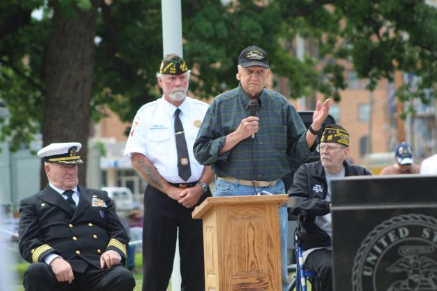 Veterans Memorial Committee member Al Brase speaks as Navy Captain David Stevens, VFW Post 1317 Commander-elect Patrick "Gunny" Koch and the VFW Chaplain looks on.