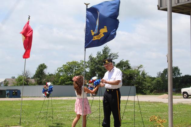 Sarah Jett places a wreath.