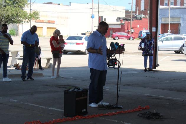 Pastor Anthony P. Rhone leads a prayer for government leaders during the Juneteenth Prayer Service, held at the pavilion on Bell and 7th streets, in Shawnee,  June 18. Five other pastors from the community also prayed for the military, media and education, church, family and the justice system.