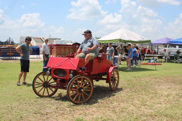 Shawnee Tractor &amp; Engine Club member Danny Dunagan drives his horseless carriage, modeled after a 1903 Runabout, during the 23rd Annual Farming Heritage Festival on June 18 at Shawnee Feed Center. Countywide &amp; Sun/Natasha Dunagan
