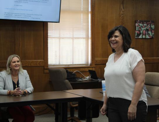 Karen Watkins is introduced to the Shawnee Board of Education, after being named SECC Principal in a previous meeting. Watkins is shown at the June 27 special meeting, as Assistant Superintendent of Personnel Dr. Teresa Wilkerson looks on. Countywide &amp; Sun/Natasha Dunagan