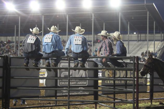 Five contestants watch the IFYR from atop a fence on July 10 at the Heart of Oklahoma Expo Center. Countywide &amp; Sun/Natasha Dunagan