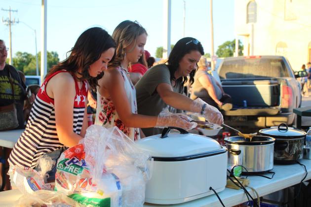 Shakotah Golden, of Asher, Lily Gregory, and Cristan Gregory, both of Wanette, prepare nachos to sell at the Wanette Independence Day event on July 4. Burgers and hot dogs were also sold to raise money for Wanette's annual Flag Day event in June.