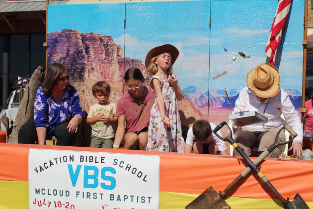 A girl on the McLoud First Baptist Church Vacation Bible School float tosses candy to the crowd during the Blackberry Festival parade on July 9. The FBC float won second in the parade. Countywide &amp; Sun/Natasha Dunagan