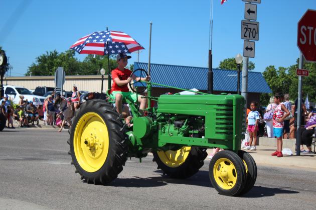 Breken Little drives a tractor in the McLoud Blackberry Festival parade on July 9. Countywide &amp; Sun/Natasha Dunagan