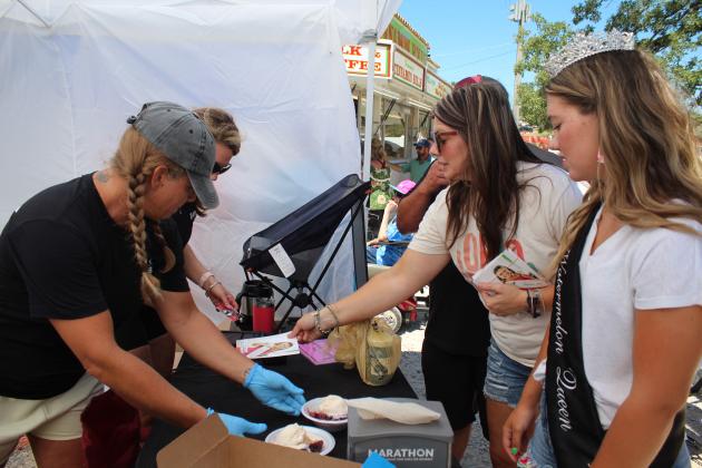 Lisa Glut and Carmen Danae, of Barbells &amp; Brisket, serve blackberry cobbler to Sara Abbott and Rush Springs Watermelon Queen Taylor Abbott during the McLoud Blackberry Festival on July 9. Each food vendor at the festival was required to serve at least one blackberry-themed food. Countywide &amp; Sun/Natasha Dunagan