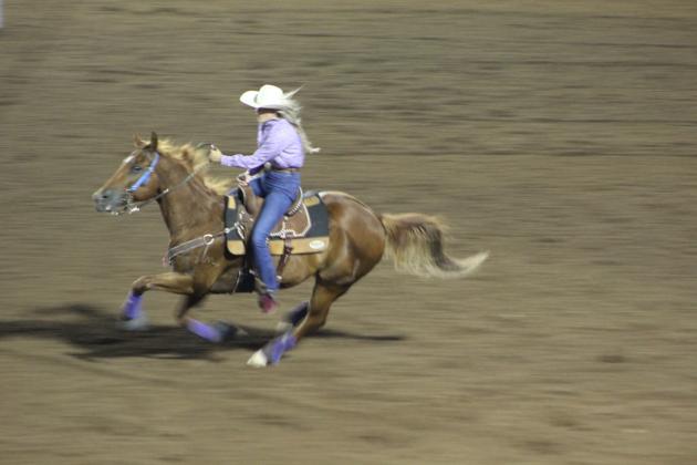 Madison Van Brunt, of Shawnee, races to the second barrel during IFYR Barrel Racing on July 11. Countywide &amp; Sun/Natasha Dunagan