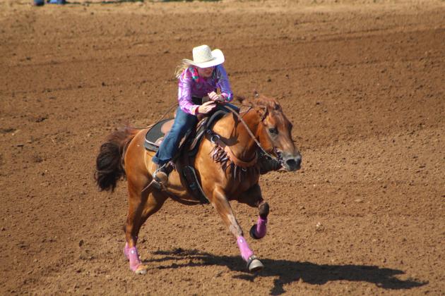 Koree Thompson, of Shawnee, completes her barrel racing run.