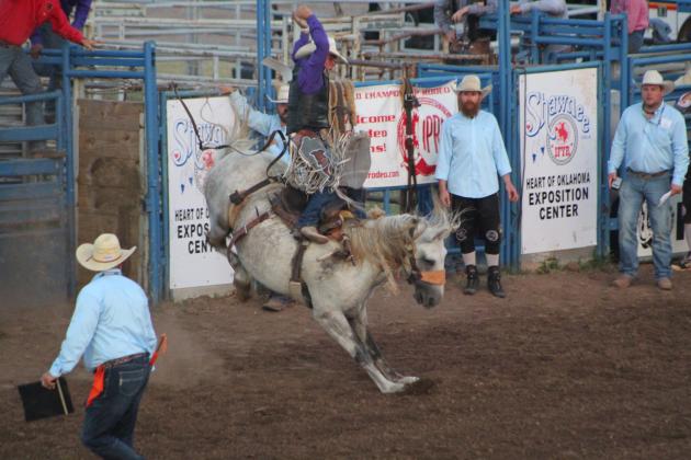 Wyatt Lavergne, of Sulphur, LA, dismounts from his horse during the finals of the IFYR Saddle Bronc event on the evening of July 15 at the Heart of Oklahoma Expo Center. Lavergne won the competition and left with a new saddle, belt buckle and cash payout. Countywide &amp; Sun/Natasha Dunagan