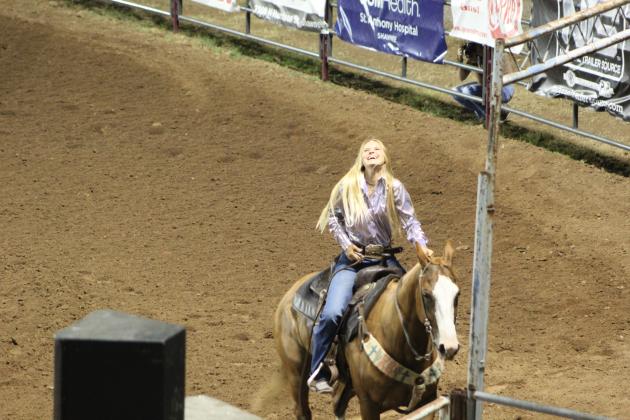 Kacey Bass, of Brenham, TX, rejoices after seeing her time in the IFYR Barrel Racing finals. She didn't win the event, but she did take home All-Around Cowgirl, as well as a saddle, belt buckle, cash payout and Cimarron horse trailer. Countywide &amp; Sun/Natasha Dunagan