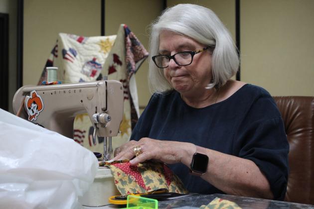 Linda Lee, of Shawnee, sews quilt squares at Quilt Camp.