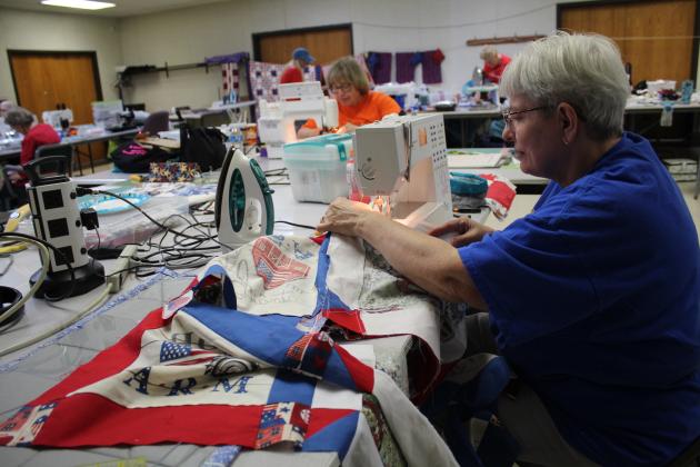 Frankie Luker, of Bethel, works on a patriotic quilt for her husband.
