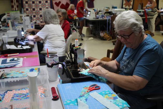 Pat Woodard, right, of Tecumseh, and Ann Cosgrove work on quilting projects at Quilt Camp on June 25.