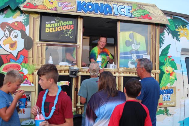 Co-owner Amy Sanders sells snowcones from the Kona Ice of Shawnee truck at FireLake Casino on July 3.