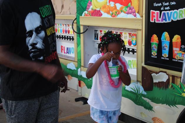 Nedra Edwards, 6, of Tecumseh, enjoys a snowcone from the Kona Ice of Shawnee truck during FireLake Casino's Independence Day event on July 3. Countywide &amp; Sun/Natasha Dunagan