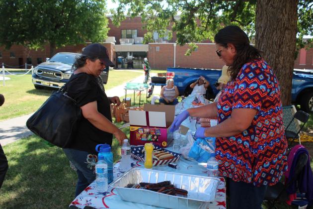 VFW Auxiliary member Justine Martin, right, points out the free hot dogs following the Oklahoma Veterans Memorial Committee Independence Day ceremony on July 4 at Woodland Veterans Park in Shawnee.