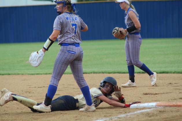 A SouthMoore runner dives back to first base, as Bethel first-baseman Payton Epperley receives the ball too late during Bethel's first fastpitch home game on Aug. 8. After a delay for rain, SouthMoore won 10-0. Countywide &amp; Sun/Natasha Dunagan