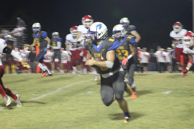 Bethel senior Corey Metscher carries the ball in the second quarter for a third down and 11 during the Homecoming Game against Washington on Oct. 1, 2021. Countywide &amp; Sun/Natasha Dunagan