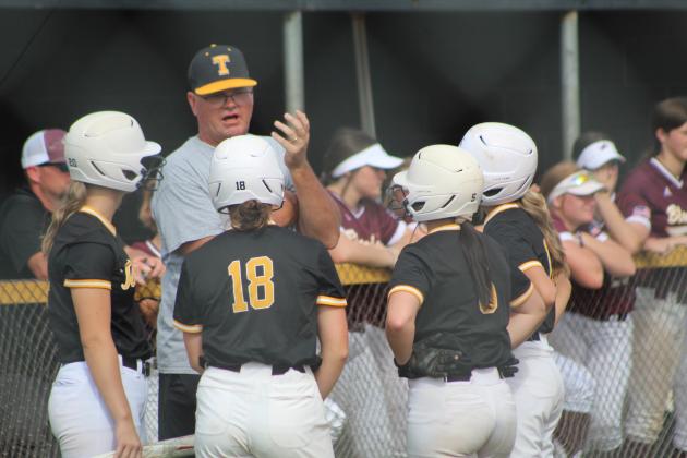 Tecumseh Coach Chad Trahan calls a meeting with his Lady Savages during the first inning of the game against Blanchard on Aug. 8. The first Tecumseh fastpitch home game of the season took a break for lightning after the second inning and was eventually rained out. Countywide &amp; Sun/Natasha Dunagan