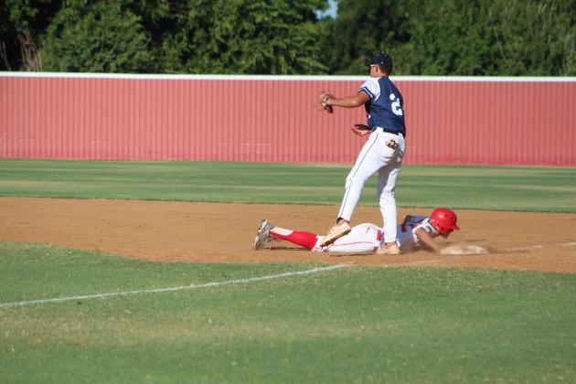 Dale's Kash Van Brunt dives back to first base after trying to steal second, as Asher first-baseman Brogan Culwell watches for the throw during the Dale home game on Aug. 18. Countywide &amp; Sun/Natasha Dunagan