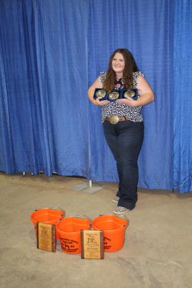 Poppy Robinson, of Dale FFA, poses with her three belt buckles, three buckets and two plaques won at the Pottawatomie County Free Fair. She won the plaques in team and individual Junior Livestock Judging; the buckets for division two and three ewes and division two wethers; and the buckles in Intermediate Showmanship, Reserve Grand Champion Wether, and the Gold Belt Buckle Hi Point Award. Countywide &amp; Sun/Natasha Dunagan