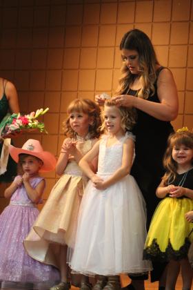 Frontier Days Pageant Coordinator Katie McMahan crowns Mae McCullough, 6, as Tot Miss Frontier Days on Sept. 11 at the Tecumseh City Hall Auditorium. Also shown, from left, are Gabriella Aguirre, 3, Kate Benge, 6, and Marianne Chastain, 3. Countywide &amp; Sun/Natasha Dunagan