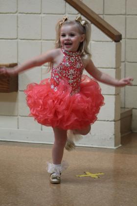 Tot contestant Autumn Hughes, 3, has fun with the Pageant Wear part of the Frontier Days Pageant on Sept. 11, held at the Tecumseh City Hall Auditorium. Countywide &amp; Sun/Natasha Dunagan