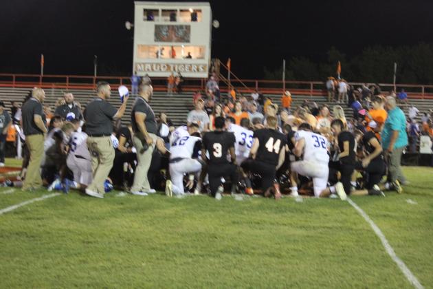 Players on the Maud and Depew teams take a knee for prayer following the Maud home game on Aug. 26. Countywide &amp; Sun/Natasha Dunagan