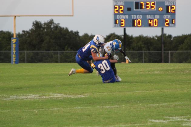 Bethel's Gabe Palomares (#30) and Luke Quinter (#44) tackle a Classen SAS player during the second quarter of the season-opening home game on Sept. 2. Countywide &amp; Sun/Natasha Dunagan