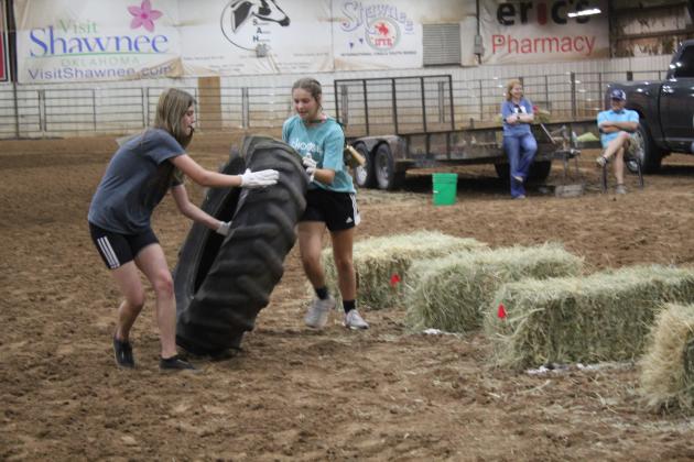 Bethel FFA members, from Team #10, Lilybeth Springer and Paityn Seiger roll a tire around hay bales during the team relay races of the 13th Annual Farmhand Olympics on Sept. 7 at the Heart of Oklahoma Expo Center. Bethel FFA Team #1 won third place, and Bethel FFA Team #2 won second place. Macomb FFA Team #2 won first. Countywide &amp; Sun/Natasha Dunagan