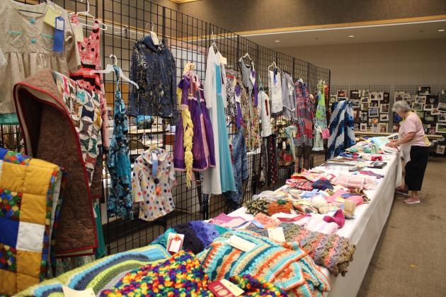 Oklahoma Home and Community Education (OHCE) Dale Chapter member and Textile Superintendent for the Pottawatomie County Free Fair, Darline Ruyle arranges her display on Sept. 8. Ruyle said the textile entries include anything made with fabric or yarn, and there were hundreds of items. Countywide &amp; Sun/Natasha Dunagan