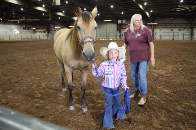 Lexi Owens, 6, of Tecumseh, leads her horse, Bo, as ring steward Cindy Bowling directs her where to go during the Pottawatomie County Horse Show on Sept. 10. This was Owens' first horse show, and Bo won third in the Senior Gelding class. The event was part of the Pottawatomie County Free Fair at the Heart of Oklahoma Expo Center. Countywide &amp; Sun/Natasha Dunagan