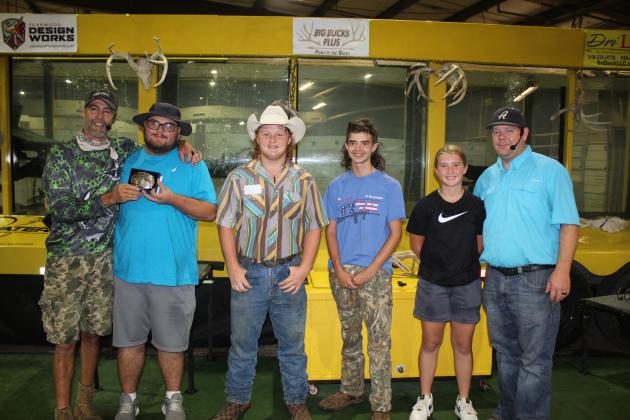 Jason Reynolds, of Fetch n’ Fish Productions, presents first place in the Pottawatomie County Free Fair Bass Fishing Tournament to Garrett Carson on Sept. 10. Carson’s bass weighed four pounds, 44 ounces. Also shown are Josh Vincent, Amadeus Sandifer, Stevie Buoy, and Fair Board Secretary Trent Boles. Vincent won second place with a three pound, seven ounce bass, and his brother, Jacob Vincent, (not shown) won third with a three pound, four ounce bass.