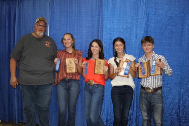 The First Place Senior FFA Livestock Judging Team from Tecumseh poses with Fair Board Member Tim Underwood, far left, during the Pottawatomie County Free Fair Awards on Sept. 10. Shown are Merli Williams, Helen Spears, Jocelyn Phelps and Taylor Marrs. Marrs also received first and Phelps received third for  Senior Individual Livestock Judging. Countywide &amp; Sun/Natasha Dunagan