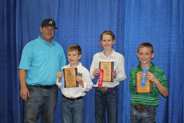 Tecumseh 4-H won first place as the Junior 4-H Horticulture Judging Team at the Pottawatomie County Free Fair. Shown, during the Fair Awards on Sept. 10, are Fair Board Secretary Trent Boles, Luke Benge, MacKenzie Benge and Preston Haines. Countywide &amp; Sun/Natasha Dunagan