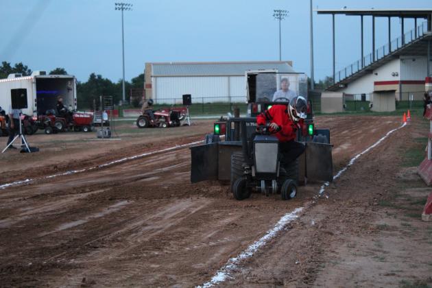 Donnie Foster makes sure he stays between the lines, pulling 157.67 feet at the Garden Tractor Pull on Sept. 10 at the Pottawatomie County Free Fair. Countywide &amp; Sun/Natasha Dunagan