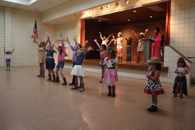 Tot, Junior and Miss contestants open the Frontier Days Pageant by dancing to the "Western Boogie" at the Tecumseh City Hall Auditorium on Sept. 11. There were 22 participants in the pageant this year, and the musical number was brought back after being absent last year. Countywide &amp; Sun/Natasha Dunagan