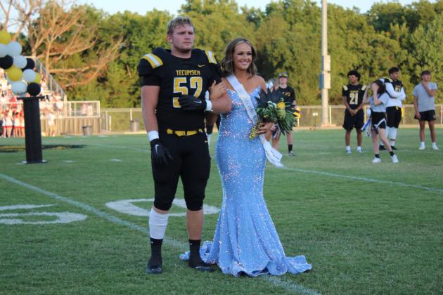 Tecumseh Homecoming Queen Candidate Sadie Boatman is escorted onto the field by senior Wyatt England during the THS Football Homecoming on Sept. 16. Countywide &amp; Sun/Natasha Dunagan