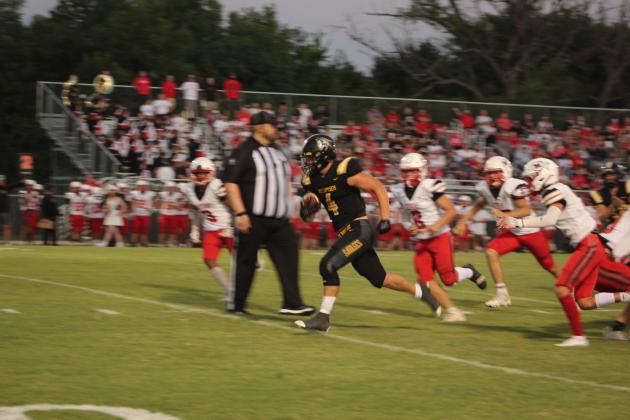 Tecumseh senior Garrett Chaffin evades a host of McLoud Redskins to make a touchdown during the Homecoming game on Sept. 16. The Tecumseh Savages won 40-14. Countywide &amp; Sun/Natasha Dunagan