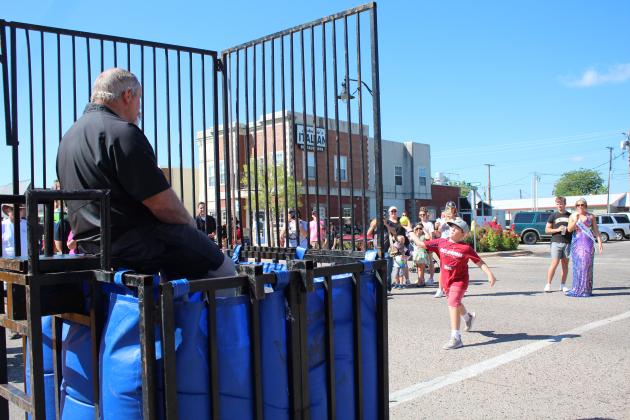 Brody Walker, 10, of Tecumseh, tries his luck at the dunk tank and submerges Tecumseh High School Principal Randy Dilbeck during Frontier Days on Sept. 17. Countywide &amp; Sun/Natasha Dunagan