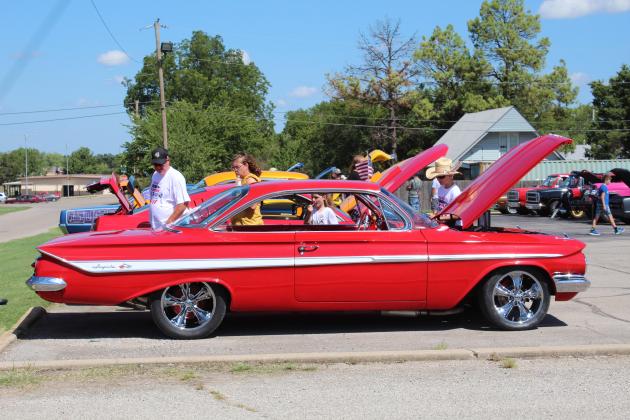 A family looks over a classic Impala during the Frontier Days Car Show on Sept. 17. There were 44 entries in this returning event. Countywide &amp; Sun/Natasha Dunagan