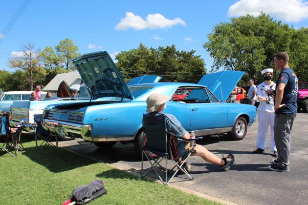 U.S. Naval Sea Cadet Madison Lockwood and her father Tacamo aircraft mechanic Robert Lockwood talk with Jerry Liles, of Tecumseh, about his 1967 Pontiac GTO during the Frontier Days Car Show on Sept. 17. Liles said the car belonged to his wife's stepfather, and it was passed down to her. Countywide &amp; Sun/Natasha Dunagan