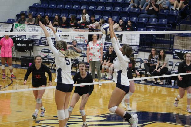 Shawnee's Harlee Bullard, far right, returns the ball, as teammate Tieryn Taylor (#5) helps at the net and North Rock Creek players, Abigail Smith (#10) and Chloe Kasterke (#13), wait. The NRC Cougars beat the Wolves 3-0 in the Shawnee game on Sept. 19. Countywide &amp; Sun/Natasha Dunagan