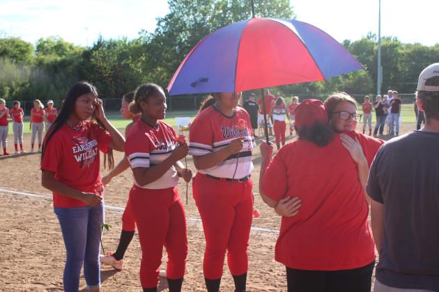 Earlsboro's Fastpitch Team "Grandma" Amelia Streater gets a hug from senior Jamie Smith during Senior Night, as Smith's teammates wait to give hugs, as well, on Sept. 20. Streater is the actual grandmother of senior Sierra Streater, and said, "I love my babies." Countywide &amp; Sun/Natasha Dunagan