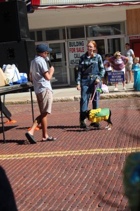 Master of ceremonies Waylon Sewell asks Paisley Gamble about her dog Olivia's corn costume, which she made that morning. Olivia placed first in medium dogs during the Monsters on Main pet contest, in downtown Shawnee, Oct. 22. Countywide &amp; Sun/Natasha Dunagan