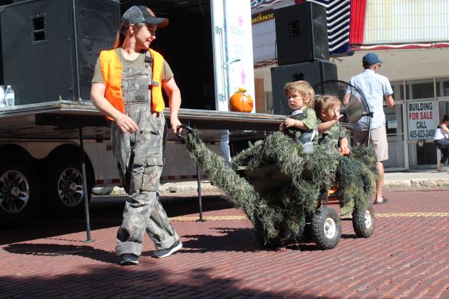 Misha Fowler, of Meeker, pulls her "Duck Commander Air Boat" with Deacon Fowler, 1, and Amelia Hennigh, 2, during the 0-3 year costume contest at Monsters on Main in downtown Shawnee, Oct. 22. Fowler won first place. Countywide &amp; Sun/Natasha Dunagan