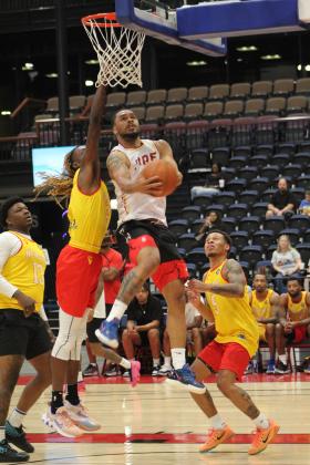 The MVP of the TBL, DeShawn Munson, goes in for a basket during the FireLake Arena Fall Shootout Basketball Tournament on Oct. 15. Munson was playing on the "Shawnee Fire" team against "New Era," and there were seven teams total in the pro-am tournament held at FireLake Arena and the Shawnee YMCA. The Fire won first in the tournament. Countywide &amp; Sun/Natasha Dunagan